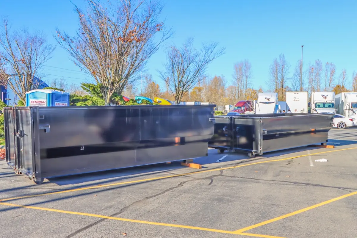 Professional dumpster rental service with roll-off container on residential driveway in Arkansas City